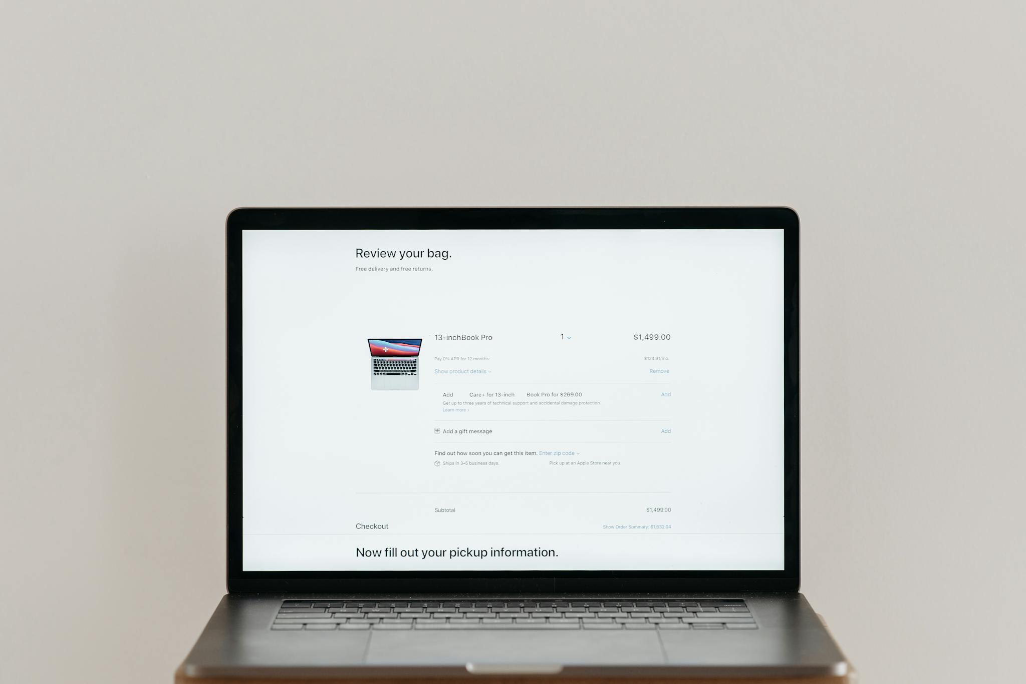 Minimalist laptop showing an online checkout screen on a white background, ideal for tech context.